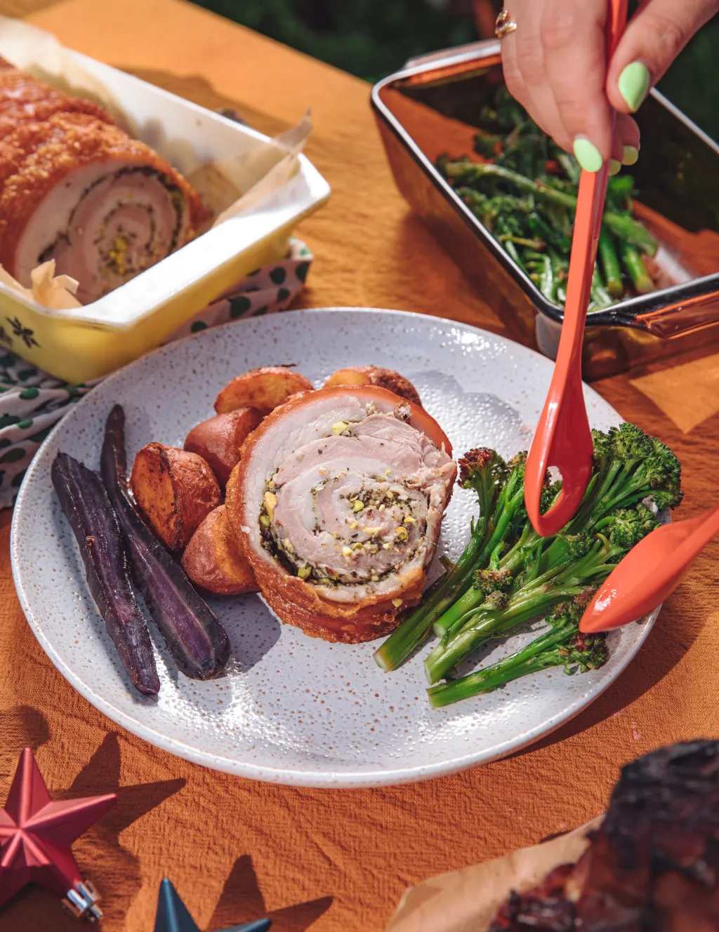 Plating of roasted meat and vegetables.