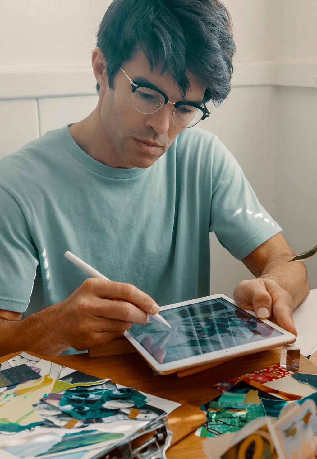 A man drawing on an iPad.