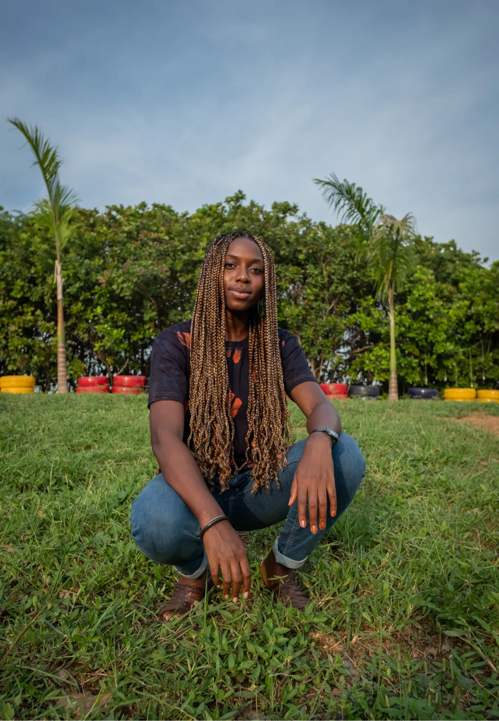 A portrait of someone in front of lush greenery.