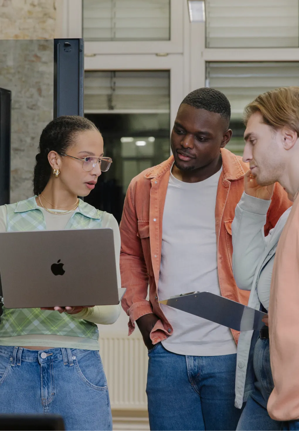 Three people working together with laptops.